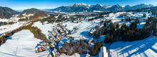 Germany, Bavaria, Oberstdorf, Aerial Panorama Of Snow-covered Town In Allgau Alps