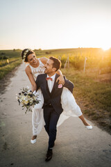 Wall Mural - Wedding in the vineyards, bride and groom in the sunset