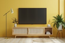 TV On Cabinet In Modern Living Room On Yellow Illuminating Wall.