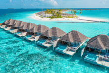 Tranquil Aerial Travel Landscape, Luxury Tropical Resort With Pool Villas. Beautiful Island Beach Shore, Lagoon Bay. Amazing Bird Eyes View In Maldives, Paradise Coast. Exotic Dream Tourism Relax Sea