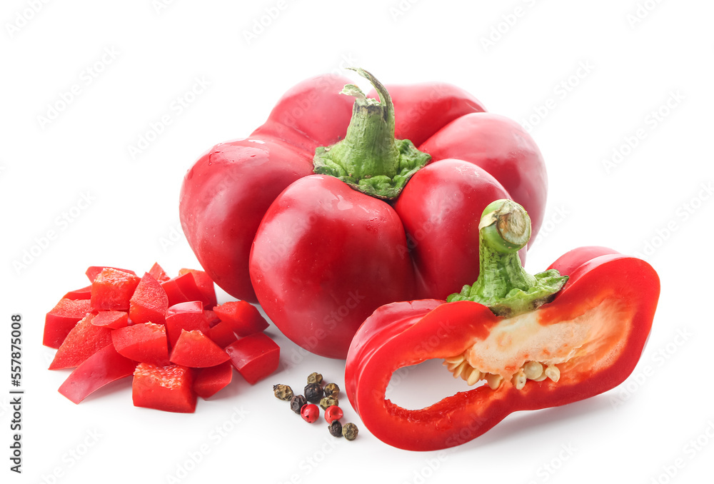 Whole and cut red bell peppers on white background