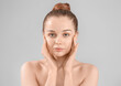 © Pixel-Shot - Pretty young woman with healthy skin on grey background