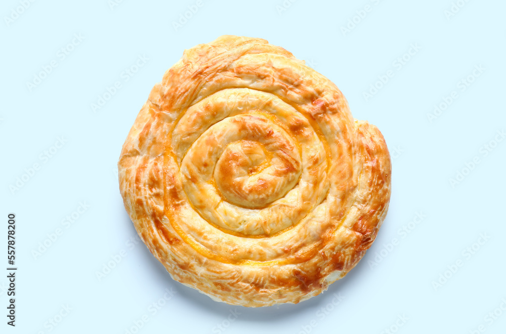 Delicious cheese pie on blue background