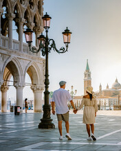 Couple On A City Trip In Venice, View Of Piazza San Marco, Doge's Palace Palazzo Ducale In Venice, Asian Women And Caucasian Men On City Trip In Venice