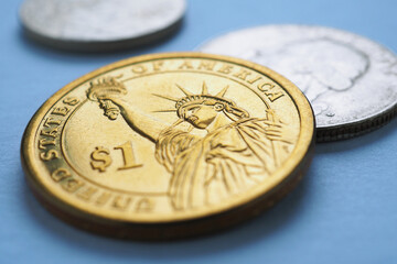 Wall Mural - american coin lies on blue surface. one dollar coin closeup. statue of liberty. sign of national cur
