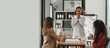 © Phushutter - Young diverse african american female coworkers working together on start up project. Business people meeting around a boardroom table discussing creative concept