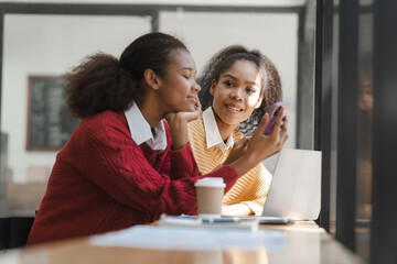 Wall Mural - African American girls students studying up for test or making homework together, Back to school concept.