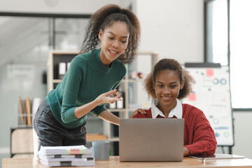 Wall Mural - African American girls students studying up for test or making homework together, Back to school concept.