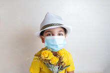 Cute And Happy Boy With Yellow T-shirt - With White Hat On Head - With Surgical Mask