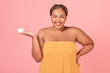 © Prostock-studio - Beauty care. Attractive black body positive woman holding jar with face cream and smiling, advertising new cosmetics