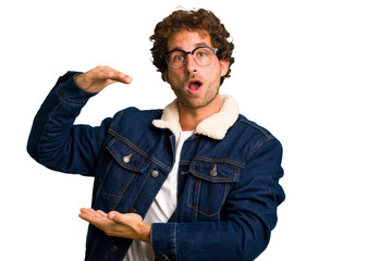 Poster - Young curly smart caucasian man cut out isolated holding something with both hands, product presentation.