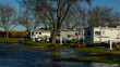 Rv trailers parked along the water edge for a relaxing camping trip on sunny day
