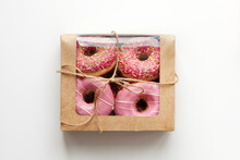 Pink Donuts Packed In Box Isolated On White Background, Natural Light