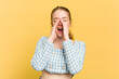 © Asier - Young caucasian redhead woman isolated on yellow background shouting excited to front.