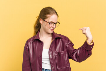 Wall Mural - Young caucasian redhead woman isolated on yellow background pointing with finger at you as if inviting come closer.