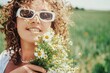 © MagicsPhotos - beautiful young woman with curly hair in a white dress with a bouquet of flowers