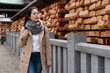 © PR Image Factory - smiling Asian Japanese girl visitor walking by a building hung with ema prayer boards at Osaka Tenmangu Shrine in japan. she looks at the wishes written on them
