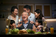three generation asian family celebrating grandpa's birthday at home