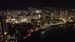 nighttime aerial view of waikiki with holiday lights and hotels on oahu hawaii night skyline and ocean wtih neighborhoods in back