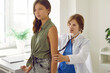 © Studio Romantic - Teen brunette girl on checkup appointment with young woman doctor examining her in clinic. Pediatrician listens her lungs with a phonendoscope. Healthcare, child pediatrician, medicine concept.