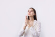 © Mountains Hunter - Portrait of a serious young woman showing stop gesture with her palm over white background