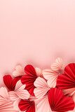 Fototapeta Mapy - Bright and passion Valentines day background - heap of mix of pink and red paper ribbed hearts on soft light pastel pink background as footer border with copy space, top view, vertical.