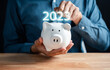 © Kiattisak - 2023 saving planning concept. man putting piggy bank for deposit banking of investment , retirement planning future saving, invest for profit and interest.