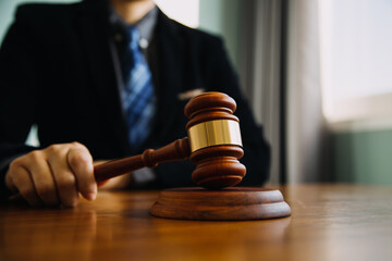 Business and lawyers discussing contract papers with brass scale on desk in office. Law, legal services, advice, justice and law concept picture with film grain effect