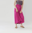 Serie of studio photos of young female model in comfortable cotton pink maxi skirt.