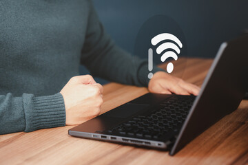 Man using a computer laptop to connect to wifi but wifi not connected, and waiting to loading digital business data form website, concept technology of waiting for connect to wifi.