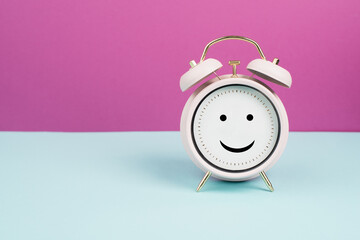 Wall Mural - Happy face on an alarm clock, mental health concept, positive emotion and mindset
