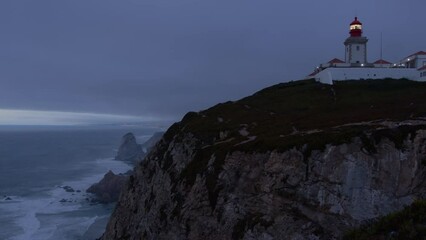 Wall Mural - beautiful dark evening panorama with farol lighthouse in the atlantic ocean at cape cabo da roca, po