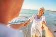 © Darren Baker - Happy Senior Old Retired Couple Dancing Holding Hands on a Beach