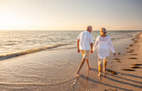 Fototapeta Big Ben - Happy Senior Old Retired Couple Walking Holding Hands on Beach at Sunset