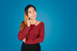 © Loeun - Pretty girl in a red shirt stands with her arms folded and points to her cheeks