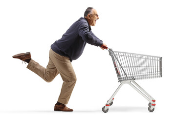 Wall Mural - Excited mature man running with an empty shopping cart