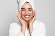 © New Africa - Young woman in bathrobe with towel on light grey background. Spa treatment