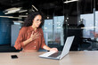 © Liubomir - Anxious and scared business woman working inside office, Hispanic woman panic attack and breathing problem, female worker with laptop working.