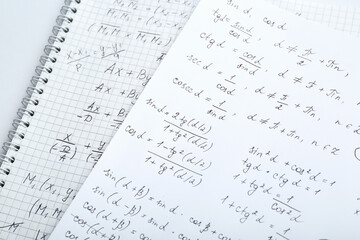 Wall Mural - Sheets of paper with different mathematical formulas on table, closeup