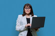 © Valerii Honcharuk - Mature business woman with laptop, on blue studio background