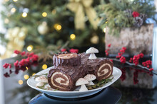Decorated Yule Log With Christmas Tree In The Background