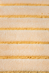 Canvas Print - Traditional Italian savoiardi ladyfinger cookies stacked together as a textured background. Macro shot of sweet sponge biscuits for tiramisu cake.