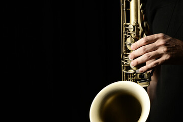 Musician's hands playing the saxophone