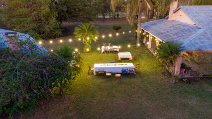 Wall Mural - Aerial view of a country house decorated for a party at sunset