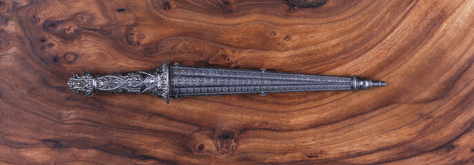 Sticker - ceremonial dagger on wooden background