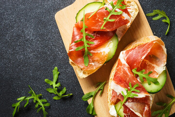 Sticker - Open sandwiches with cream cheese, prosciutto, cucumber and arugula.