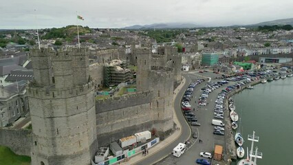 Wall Mural - Aerial view of Caernarfon Castle and the surrounding coastal area in North Wales, UK