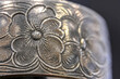 Macro of flower pattern engraving on a brass amulet