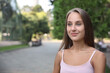 © New Africa - Portrait of beautiful young woman on city street, space for text