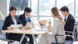 © Bangkok Click Studio - Millennial Asian young professional successful male female businessmen businesswomen employee in formal suit sitting smiling discussing communicating together in company office meeting room workplace